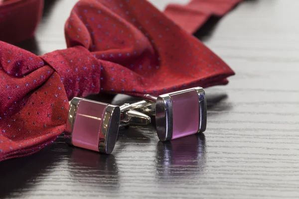 Cuff links and red bow tie