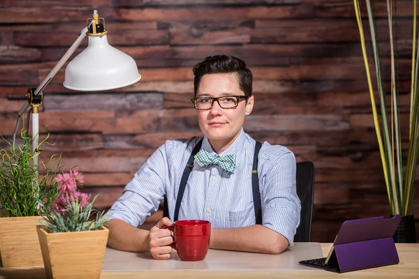 Confident Female in Bowtie with Mug