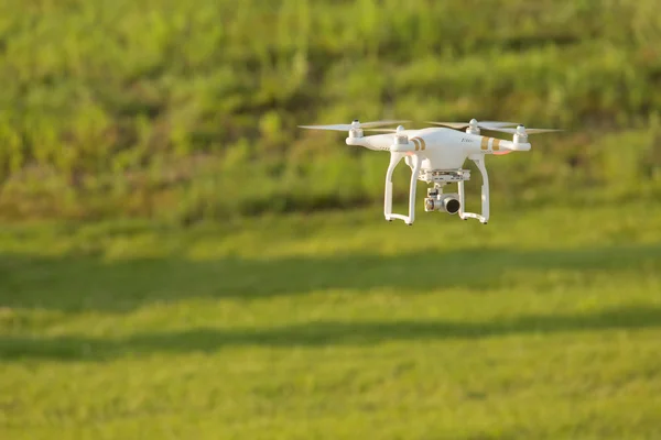 Remote control drone flying over a field