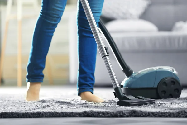 Woman cleaning the carpet