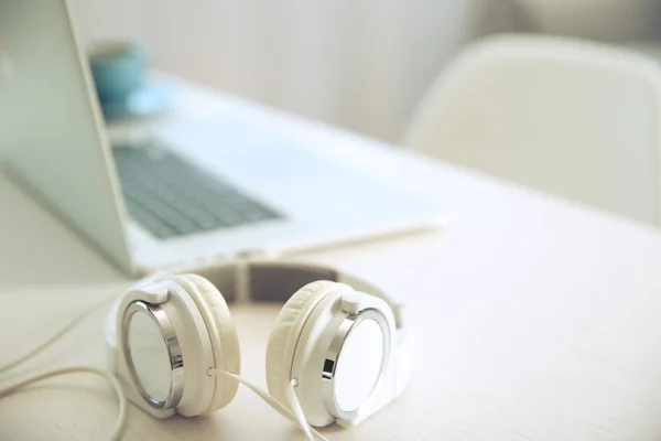 Headphones and laptop on table