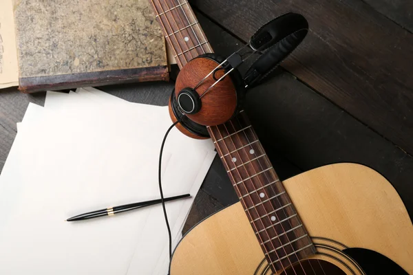 Acoustic guitar, headphones, musical notes