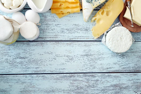 Frame of fresh dairy products on blue wooden table