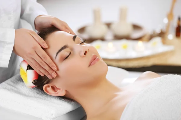 Woman relaxing with face massage