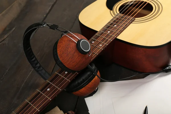 Acoustic guitar, headphones, musical notes