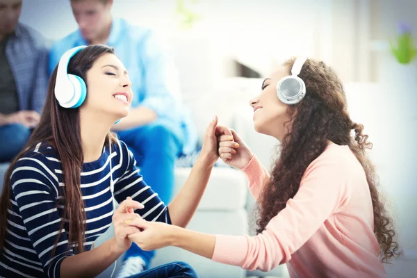 Two teenager girls listening to music