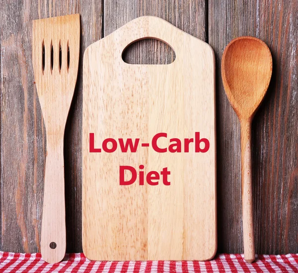 Text Low-Carb Diet on cutting board on wooden planks background