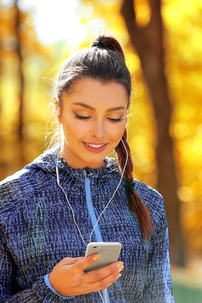 Young beautiful woman holding phone