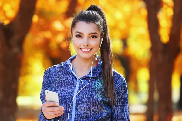 Young beautiful woman holding phone,