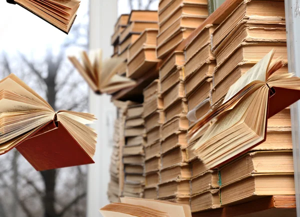 Flying books on library bookshelves