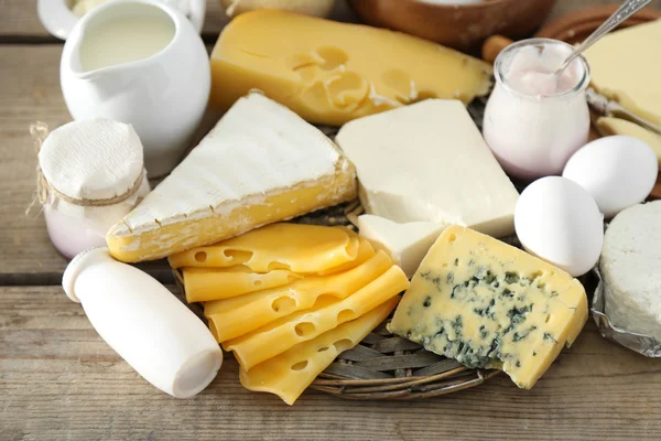 Set of fresh dairy products on old  wooden table, close up