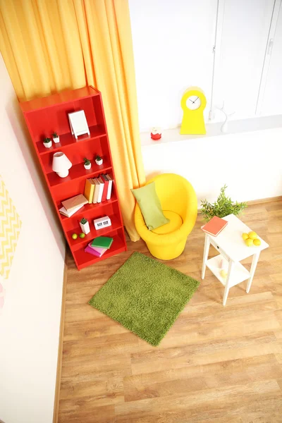 Modern living room interior with red bookcase and yellow chair