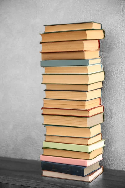 Stack of books on wall background