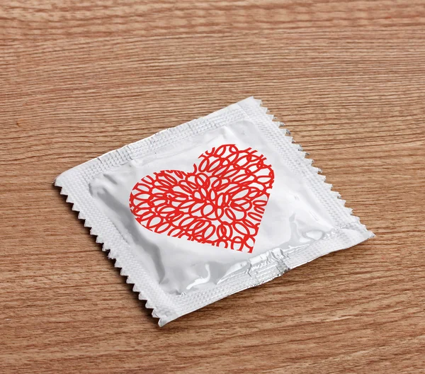 Condom with heart on  table