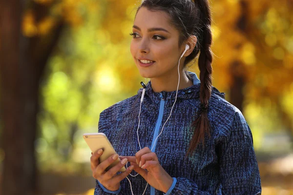 Young beautiful woman holding phone