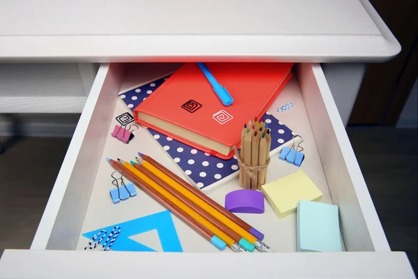 Stationery in open desk drawer