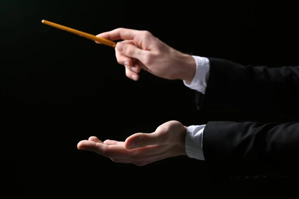 Music conductor directing with baton
