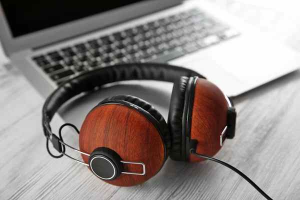 Headphones and laptop on table