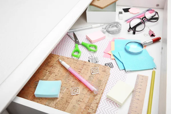 Stationery in open desk drawer