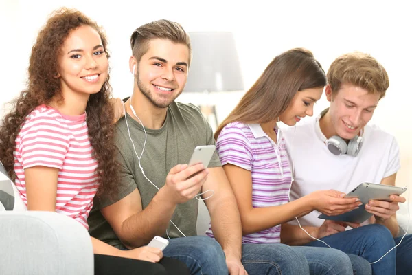 Two teenager couples listening to music