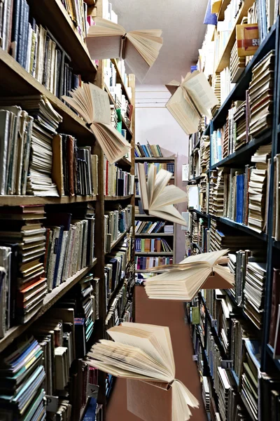 Flying books on library bookshelves