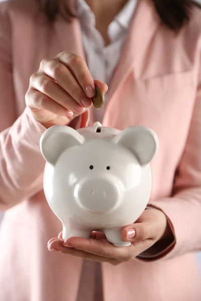 Woman holding piggy bank