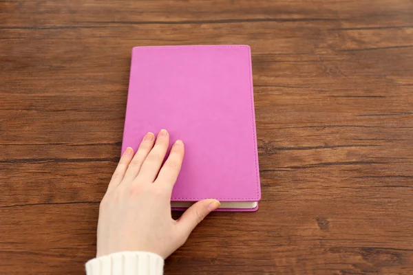 Female hand holding a book