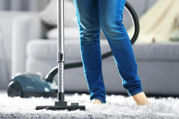 Woman cleaning the carpet