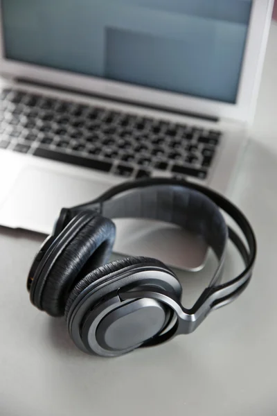 Headphones and laptop on table