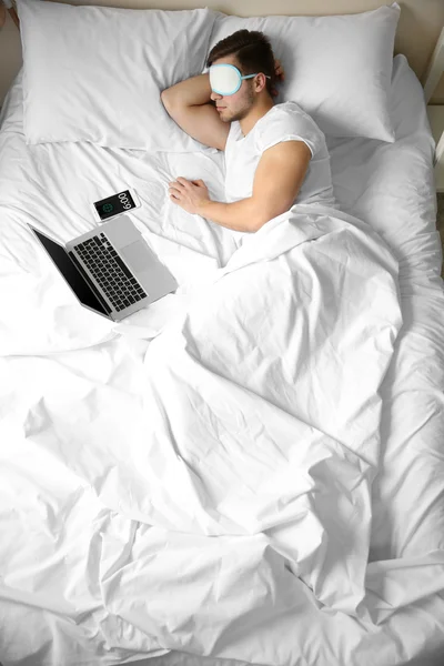 Young man sleeping with blindfold