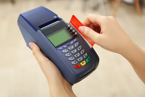 Hands with credit card and bank terminal