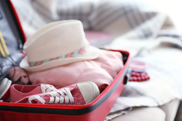 Woman\'s clothes in a red suitcase, close up