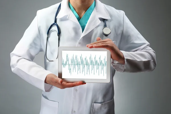 Doctor holding tablet in hands