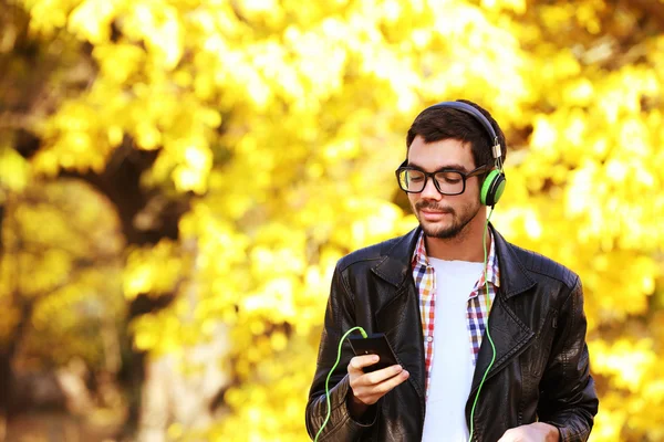 Man listening to music in a park