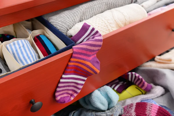 Pile of clothes in open drawer