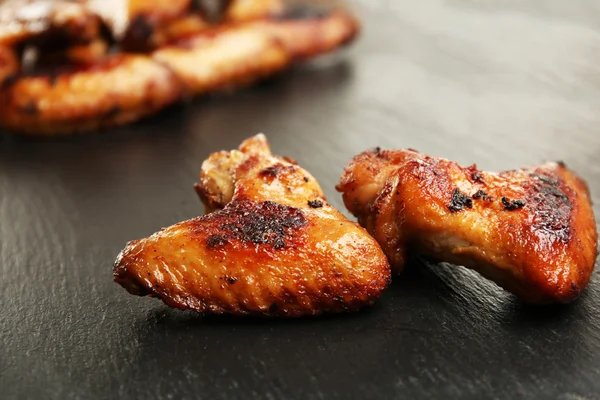 Baked chicken wings on slate plate