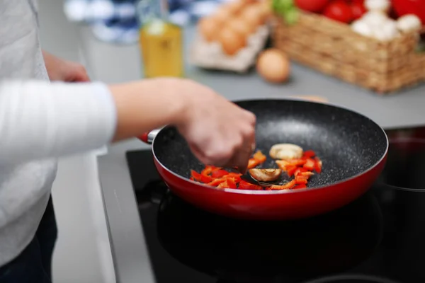 Human hands with frying pan