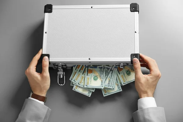 Businessman with case full of money