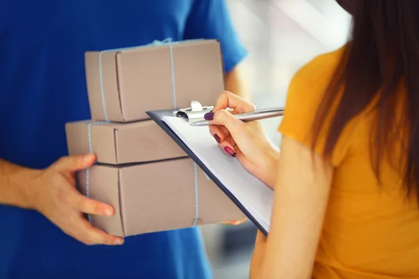 Woman signing delivery receipt