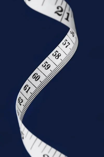 White measuring tape on a black background
