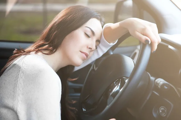 Woman asleep on steering wheel