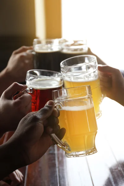 Friends drinking beer in pub