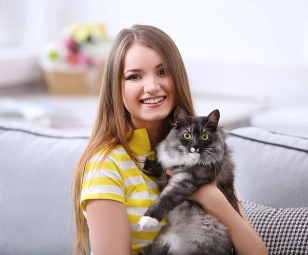 Young woman with cat at home