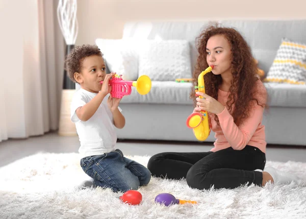 Boy and girl playing with musical toys