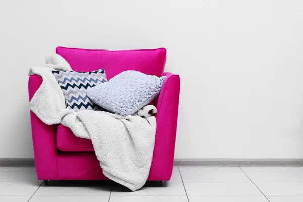 Pink armchair with blanket
