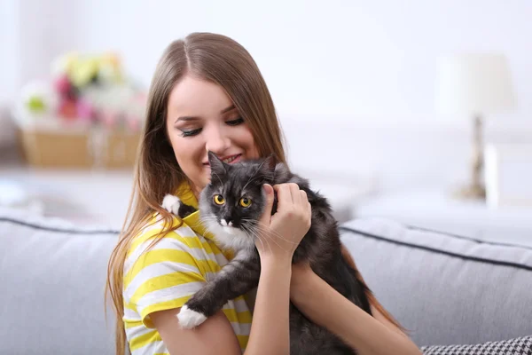 Young woman with cat at home