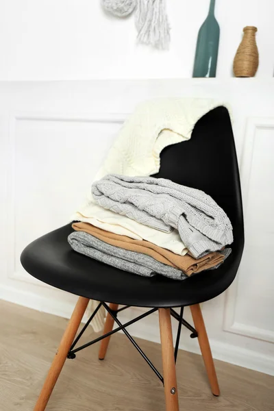 Stack of clothes on black chair