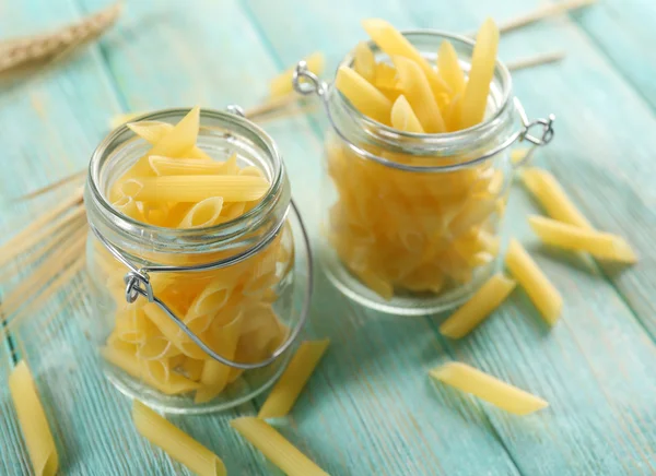 Raw pasta in glass jars