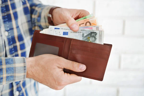 Female hands holding leather purse