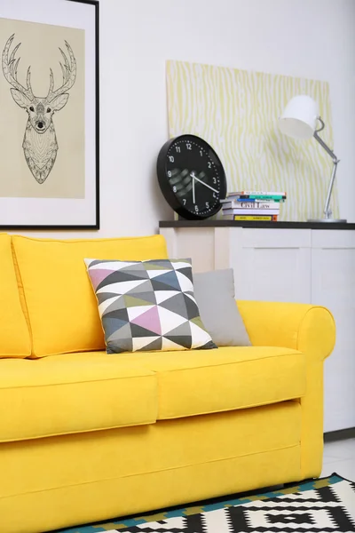 Yellow sofa against wall